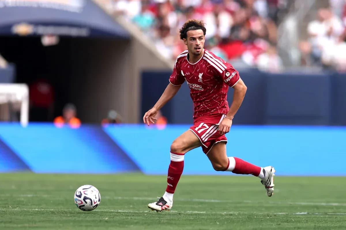 Liverpool player dribbling ball during match