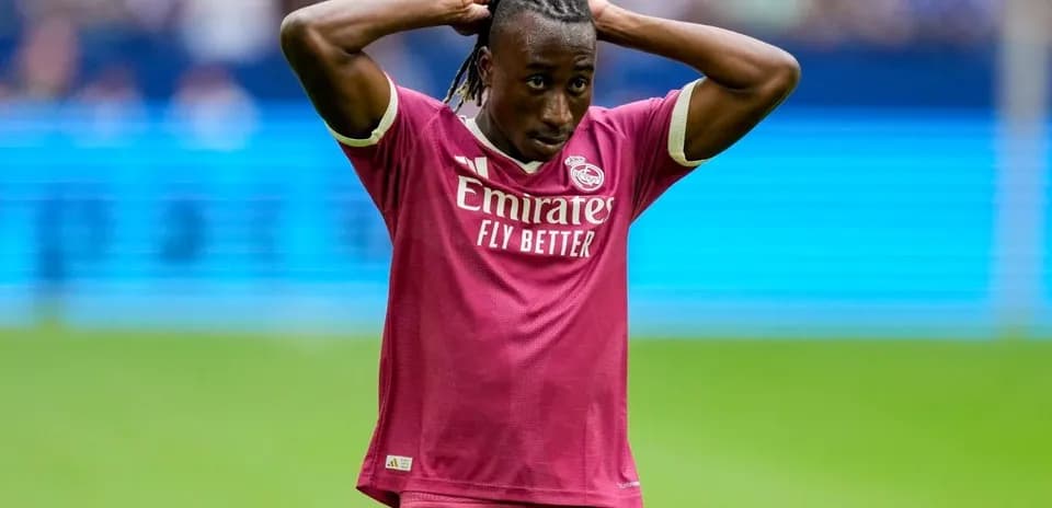 Player in pink jersey with hands on head