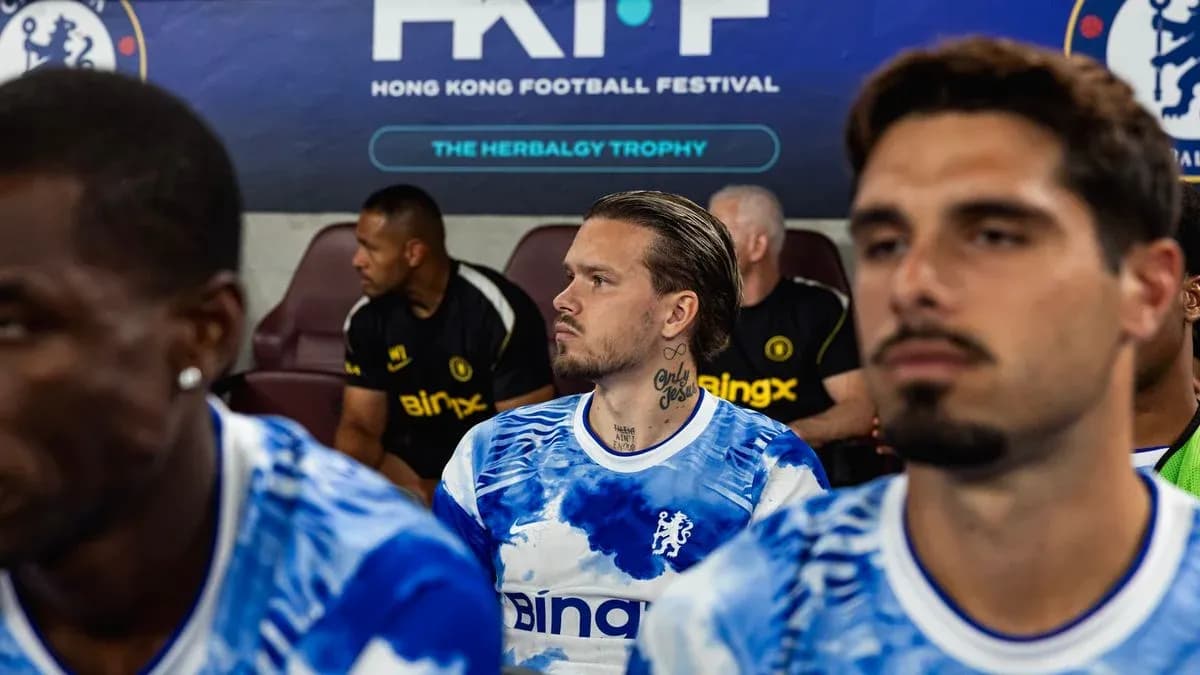 Chelsea players sitting on bench during match warm-up