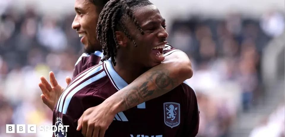 Two Aston Villa players celebrating a goal