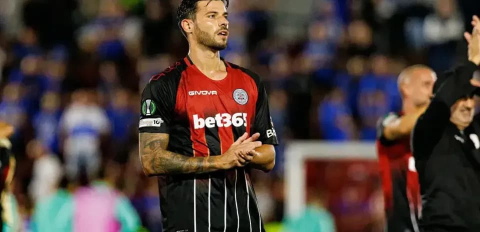 Player applauding fans after UEFA match