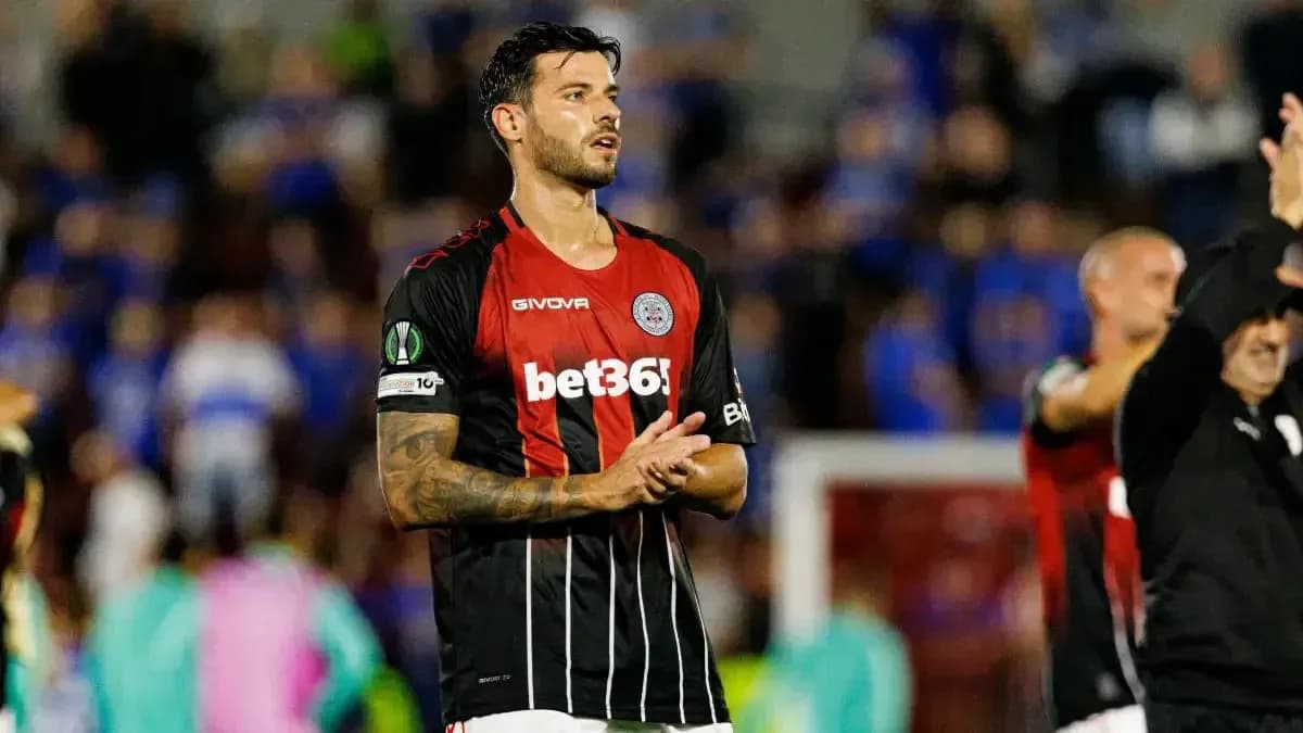 Player applauding fans after UEFA match