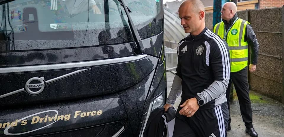 Team arriving at bus in rainy weather