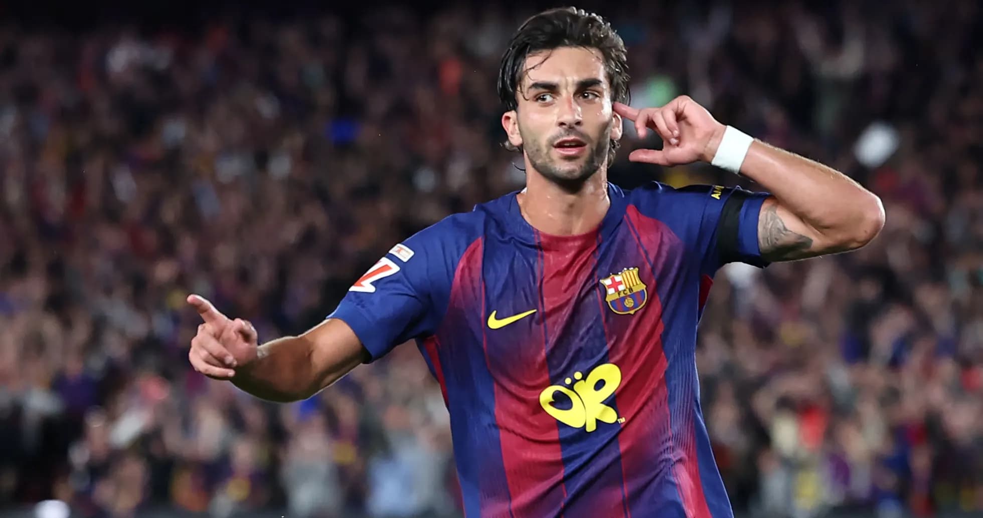 Barcelona player celebrating a goal with fans