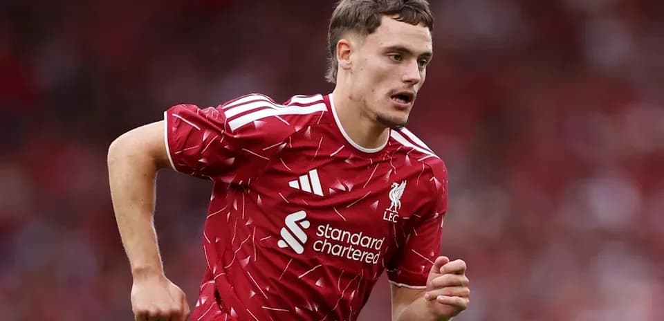 Player running on the field in Liverpool kit
