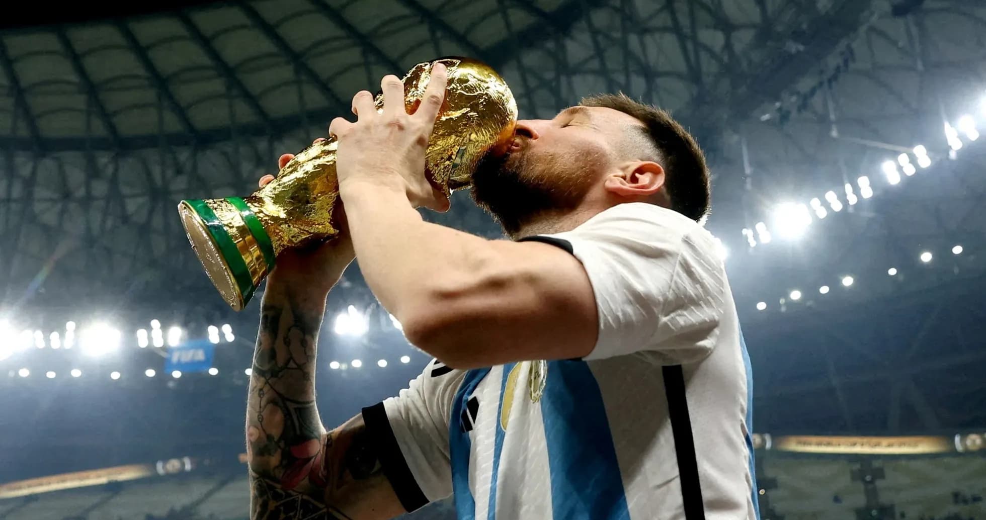 Player celebrating by kissing World Cup trophy