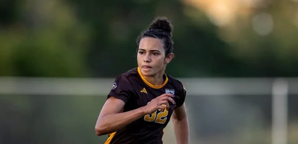 Player in brown uniform running on the field