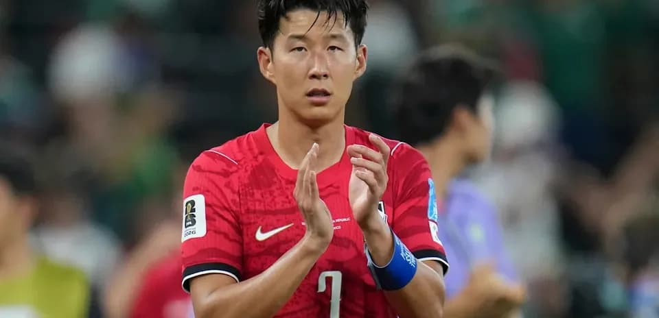 Player applauding after match in red jersey