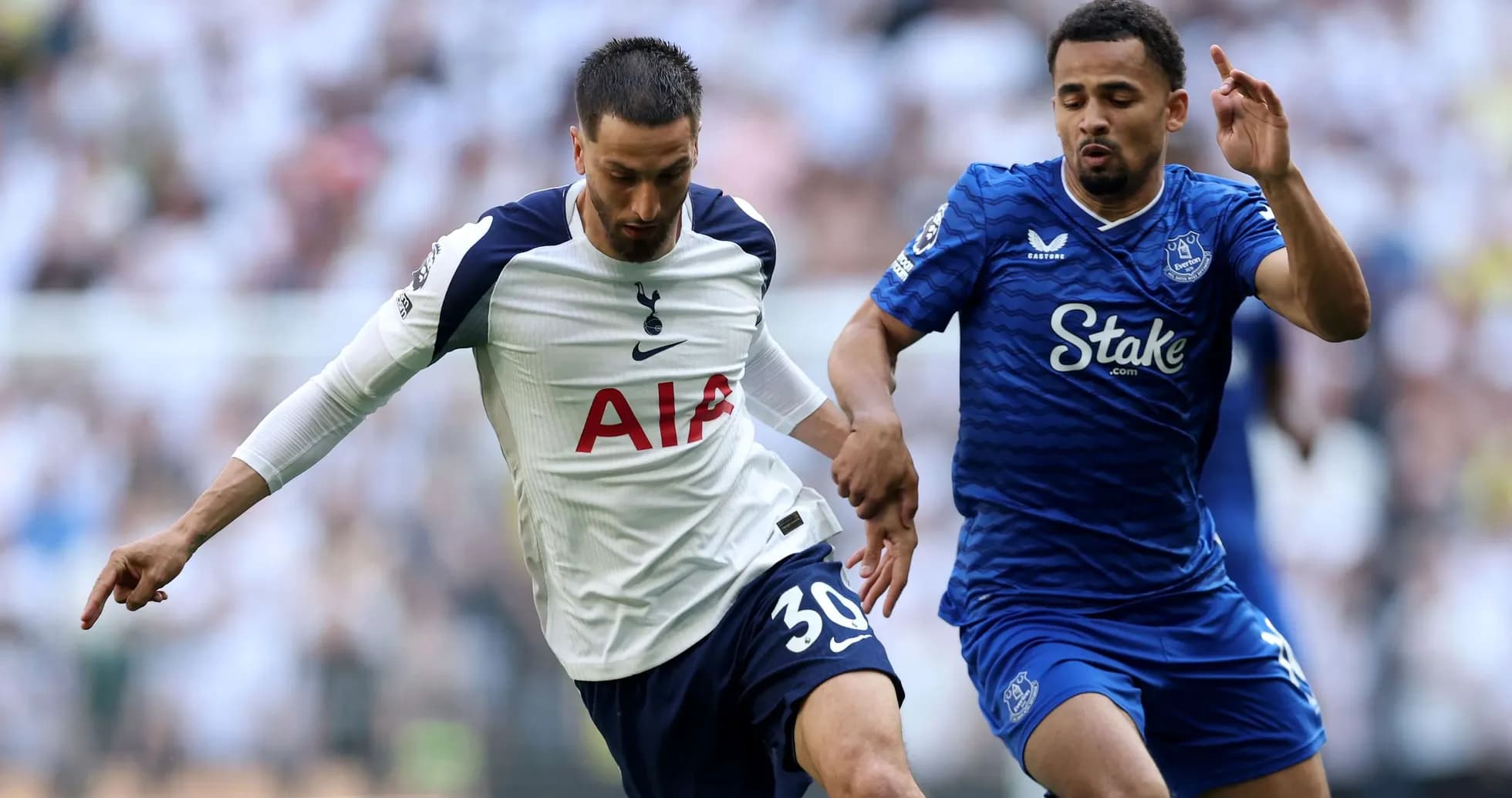 Player from Tottenham challenges Everton opponent