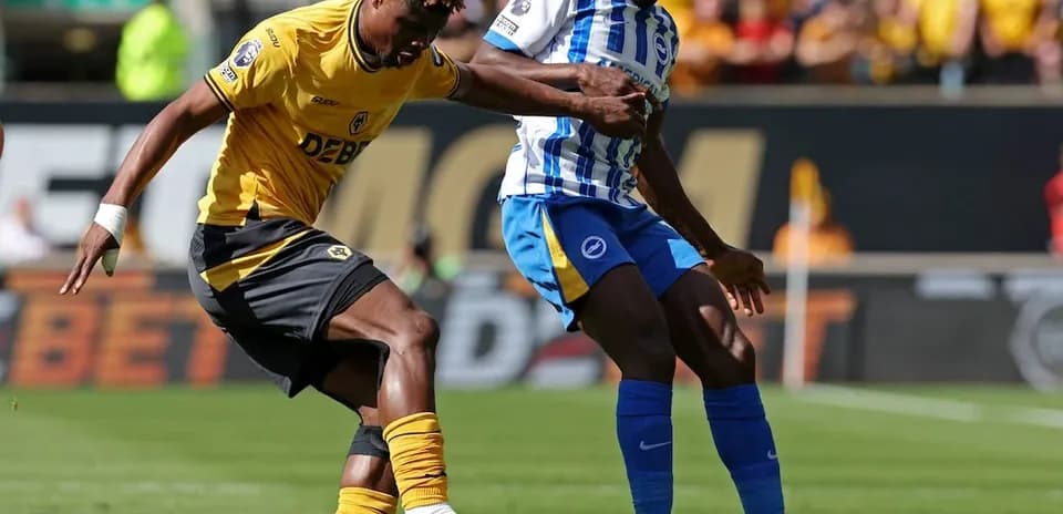 Brighton player tackles Wolves player during match