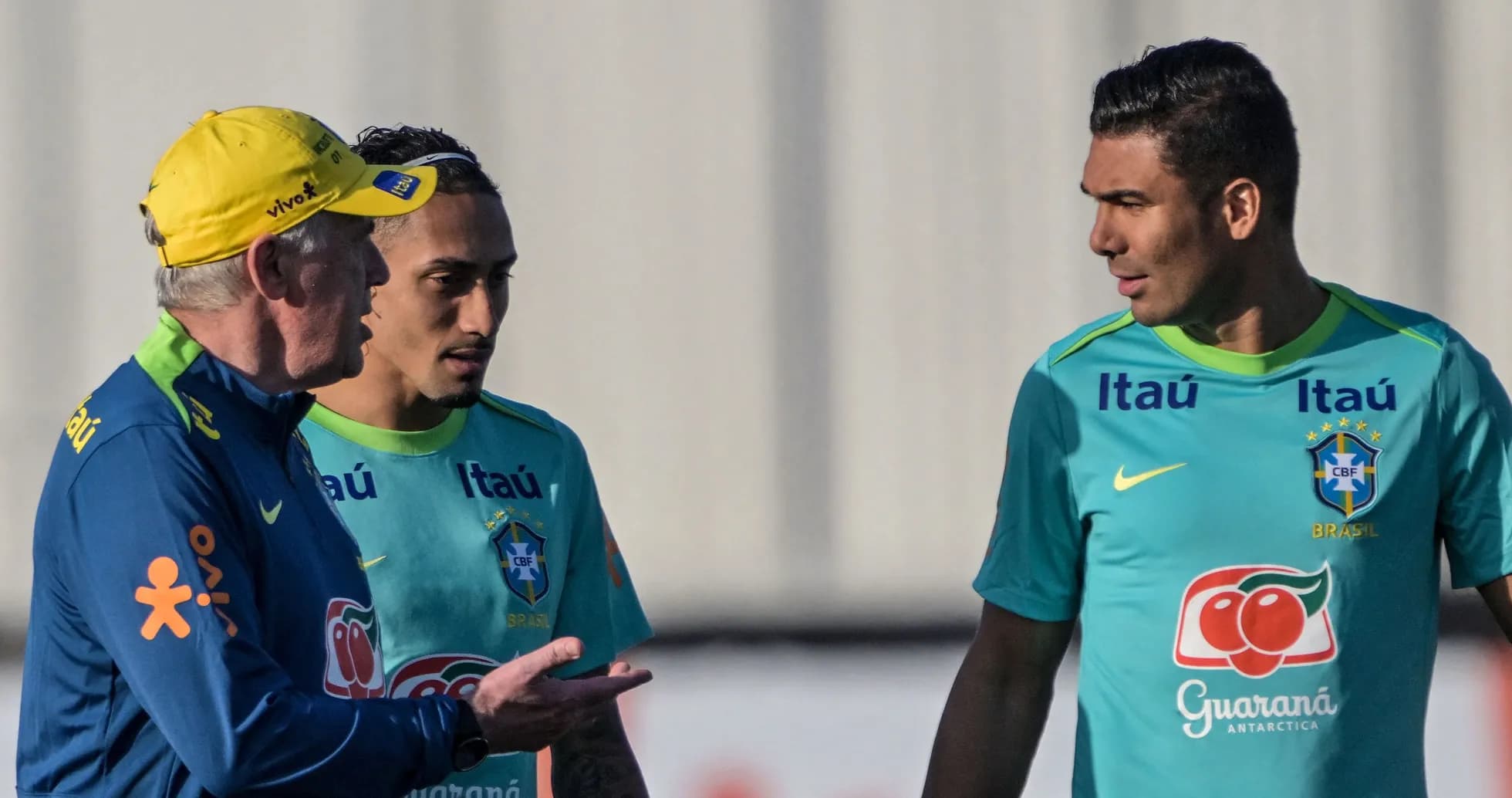 Coach discussing with two Brazilian players during training