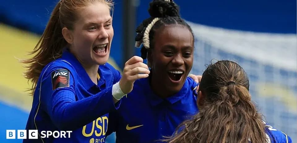 Players celebrating a goal on the field