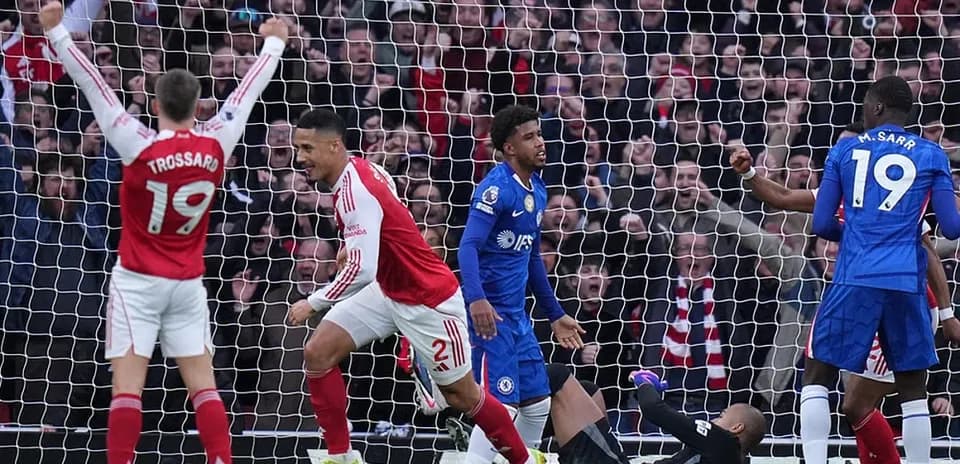 Arsenal players celebrate a goal against Chelsea