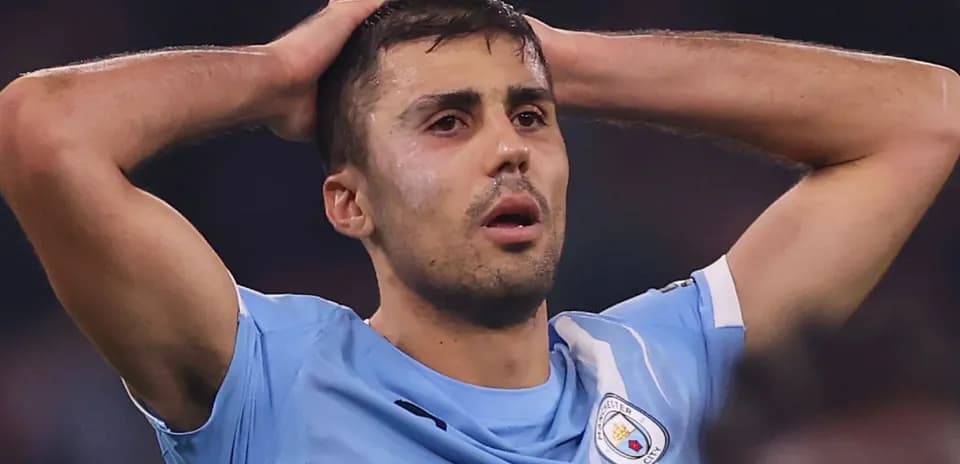 Player holding head in disappointment on the field