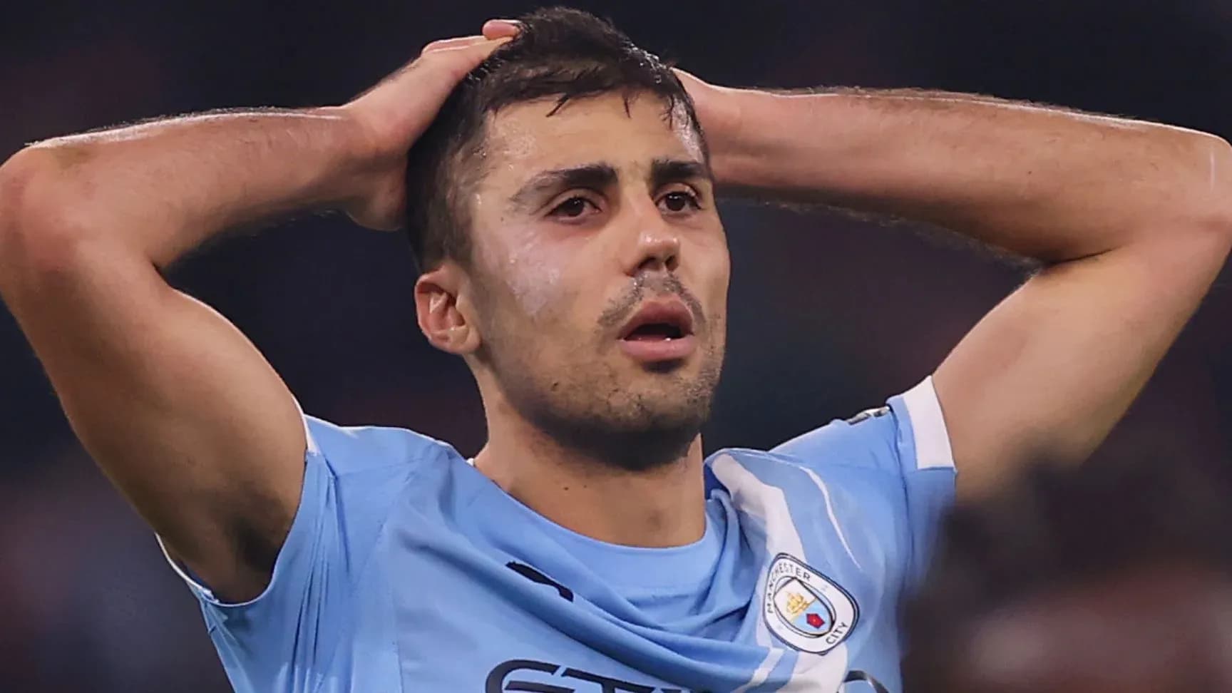 Player holding head in disappointment on the field