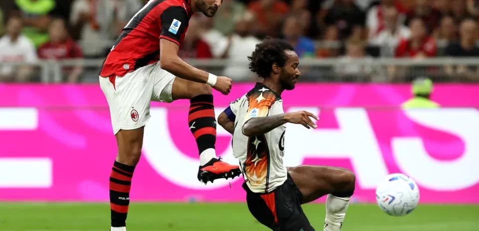 AC Milan player challenging Venezia opponent