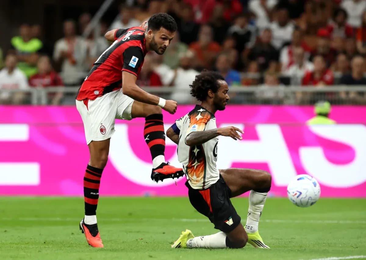 AC Milan player challenging Venezia opponent