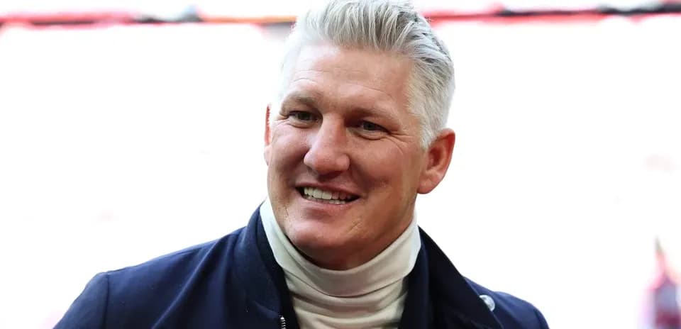 Man smiling in a sports venue setting