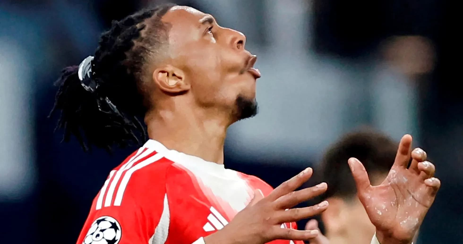 Player looking up with hands raised in match