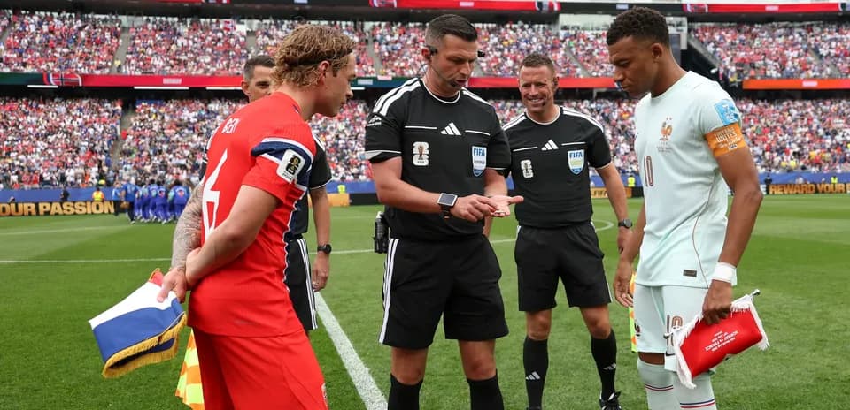 Players and referees at coin toss before match