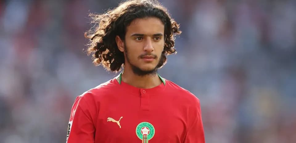 Player in red jersey walking on field