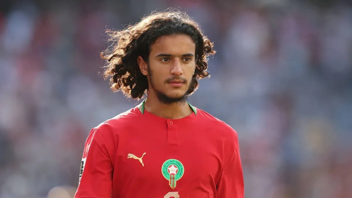 Player in red jersey walking on field