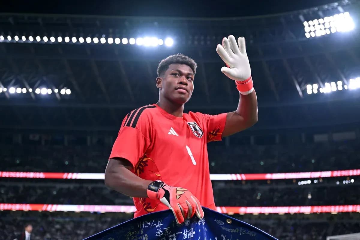 Goalkeeper waving while holding a team banner