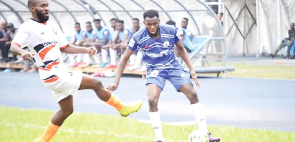 Rivers United player dribbling against Plateau United