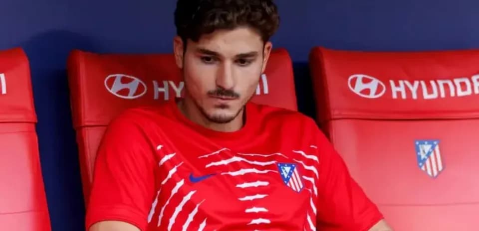Player sitting on bench in red team kit