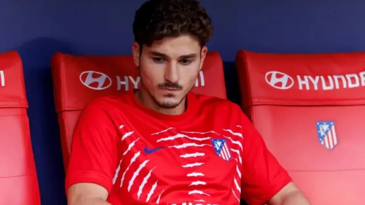 Player sitting on bench in red team kit