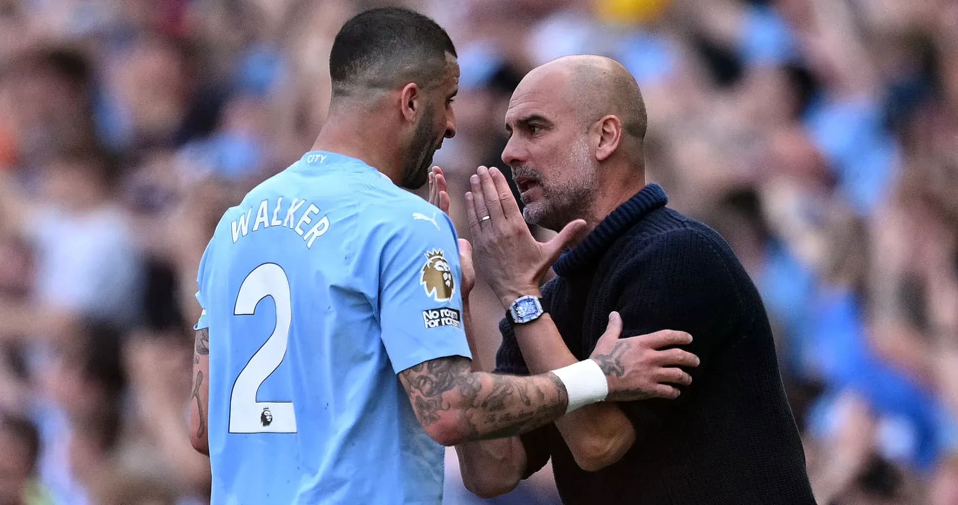 Kyle Walker discussing strategy with Pep Guardiola