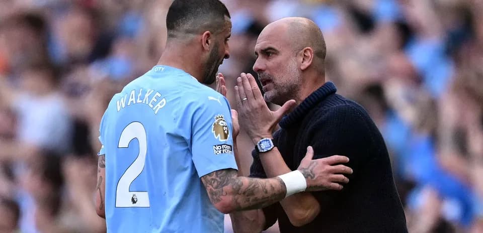 Kyle Walker discussing strategy with Pep Guardiola