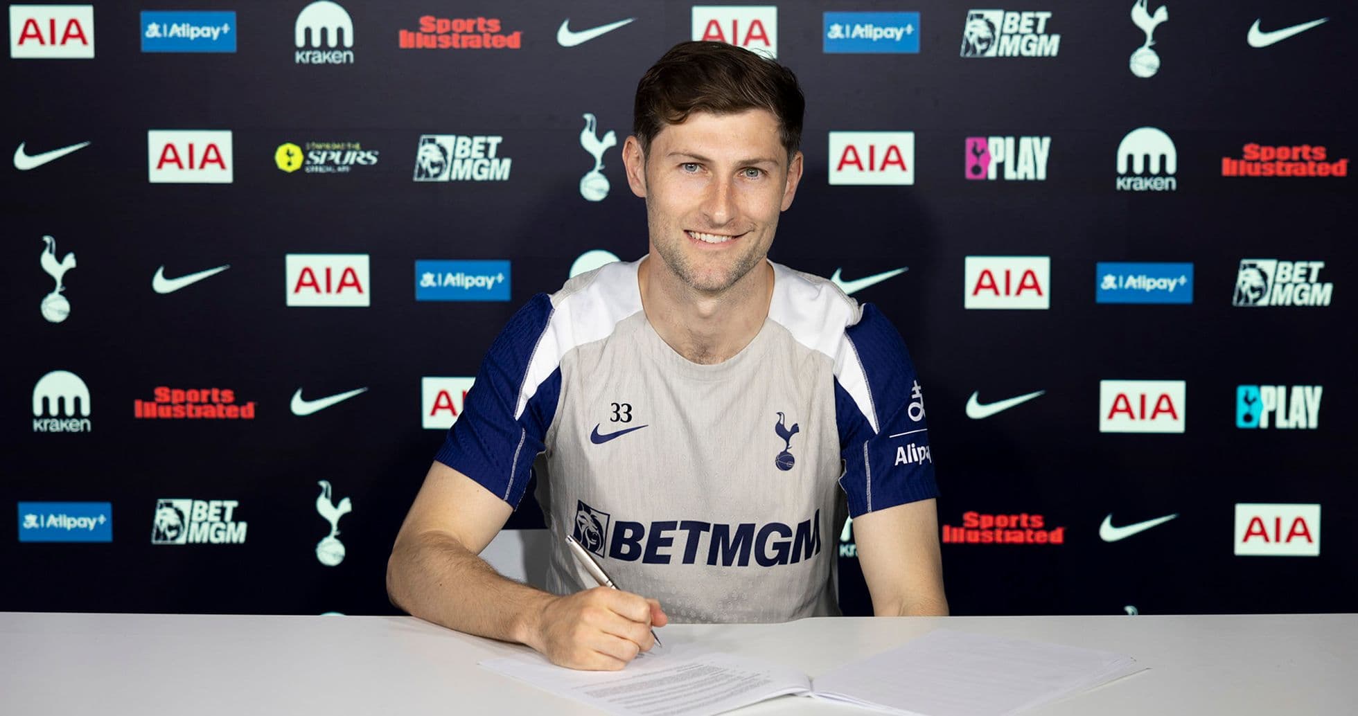 Player signing contract at Tottenham press conference