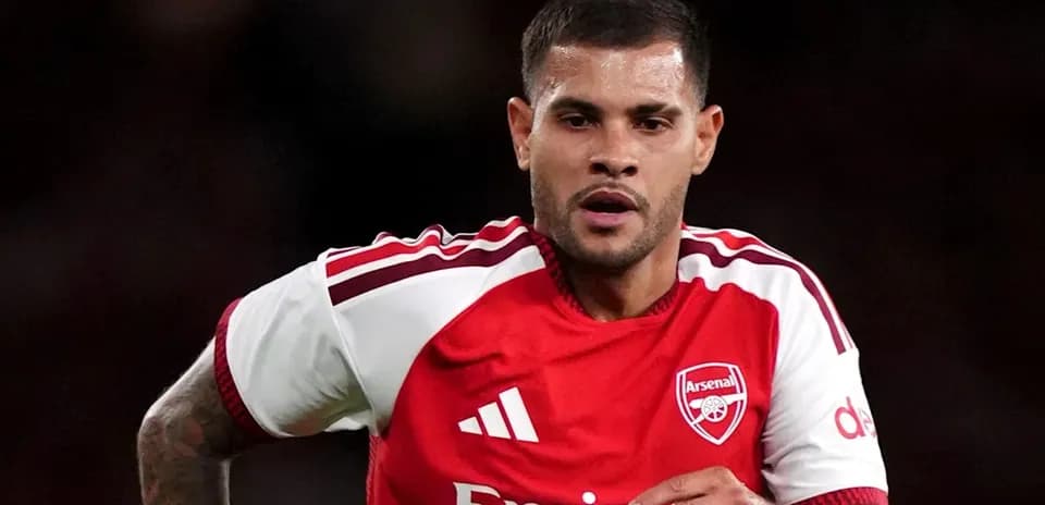 Player running in Arsenal kit during match