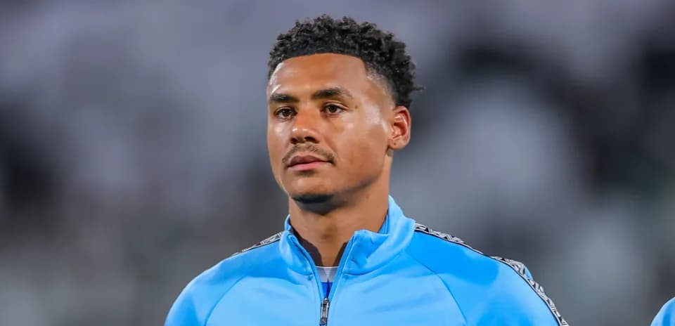 Player in blue training jacket during match warm-up