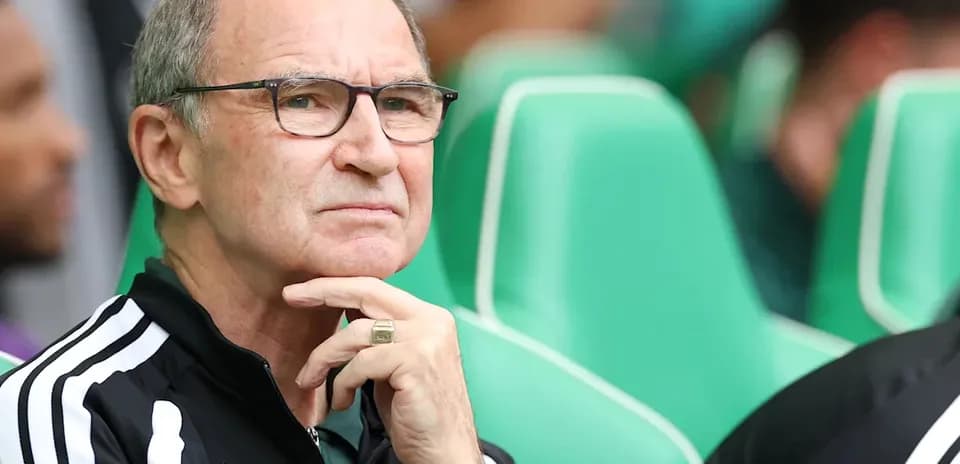 Coach pondering during a match on the sidelines
