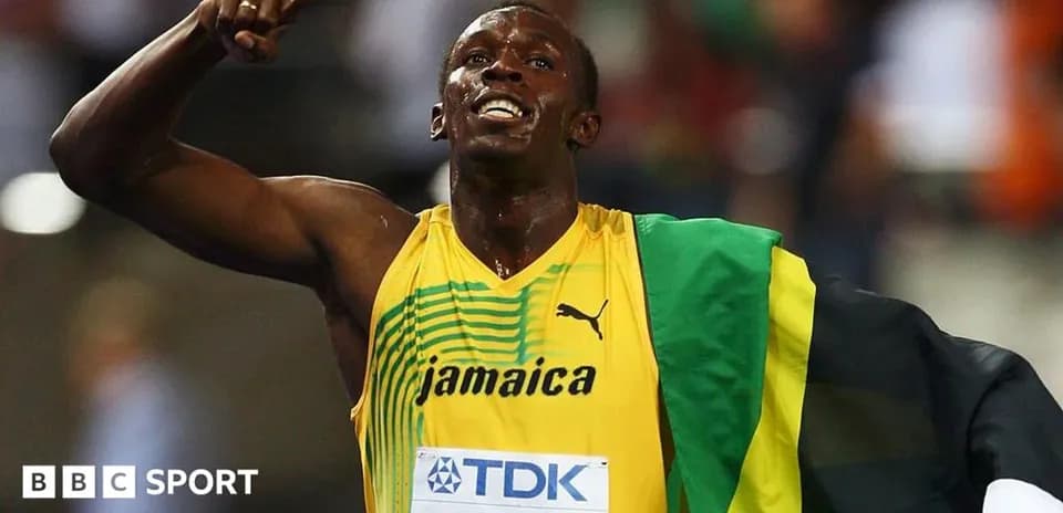 Athlete celebrating victory with Jamaican flag draped
