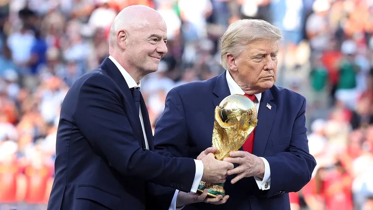 Gianni Infantino and Donald Trump holding World Cup trophy