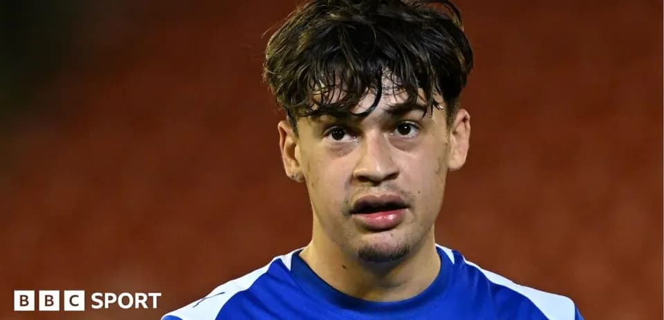 Player wearing blue jersey during post-match interview