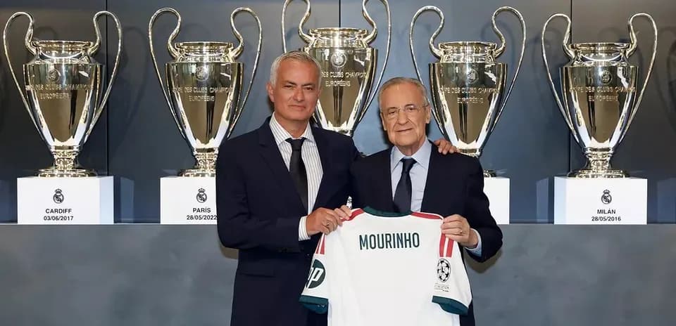 Jose Mourinho holding a jersey with Florentino Perez