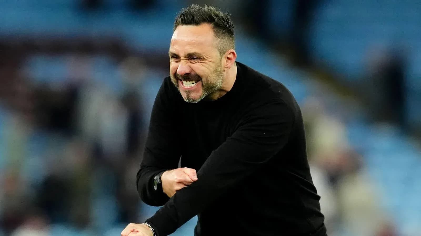 Coach celebrating enthusiastically during a match