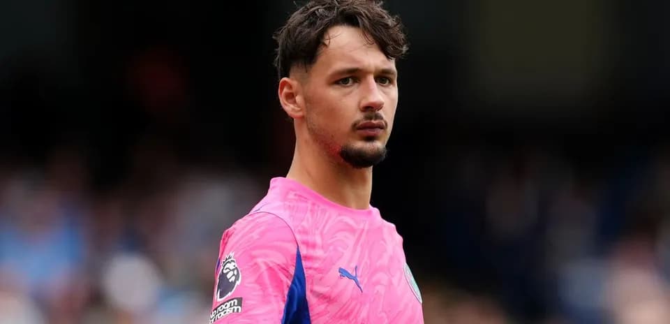 Goalkeeper in pink kit on the field