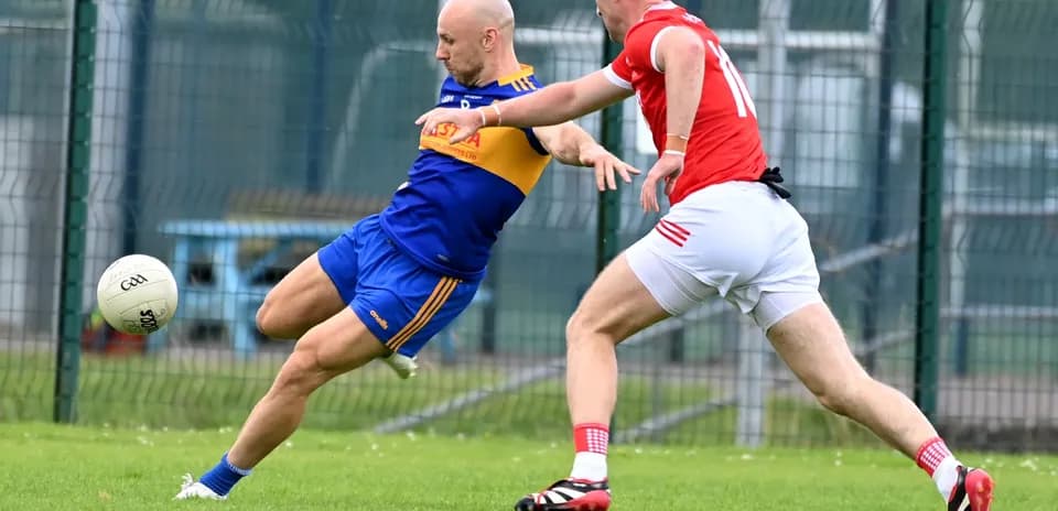 Player kicking the ball while being challenged