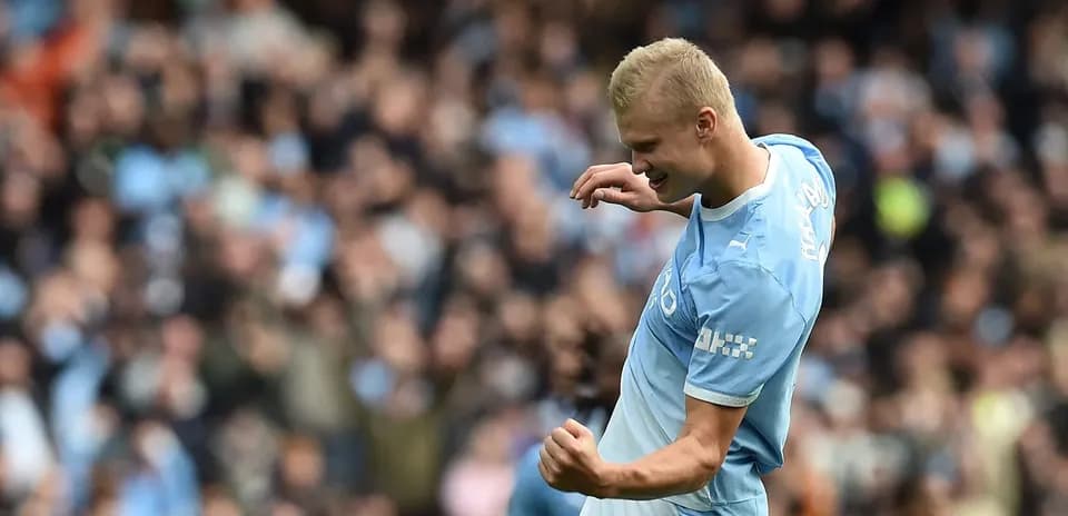 Player celebrating a goal with fans in background