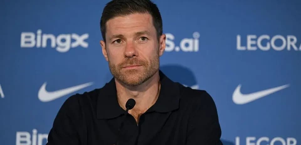 Manager speaking at press conference with microphone
