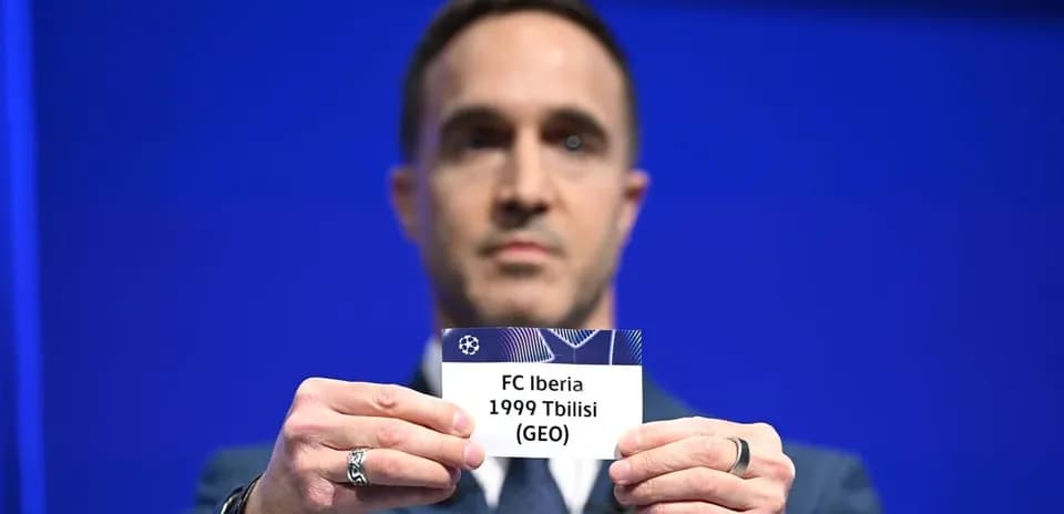 Man holding FC Iberia 1999 Tbilisi draw card