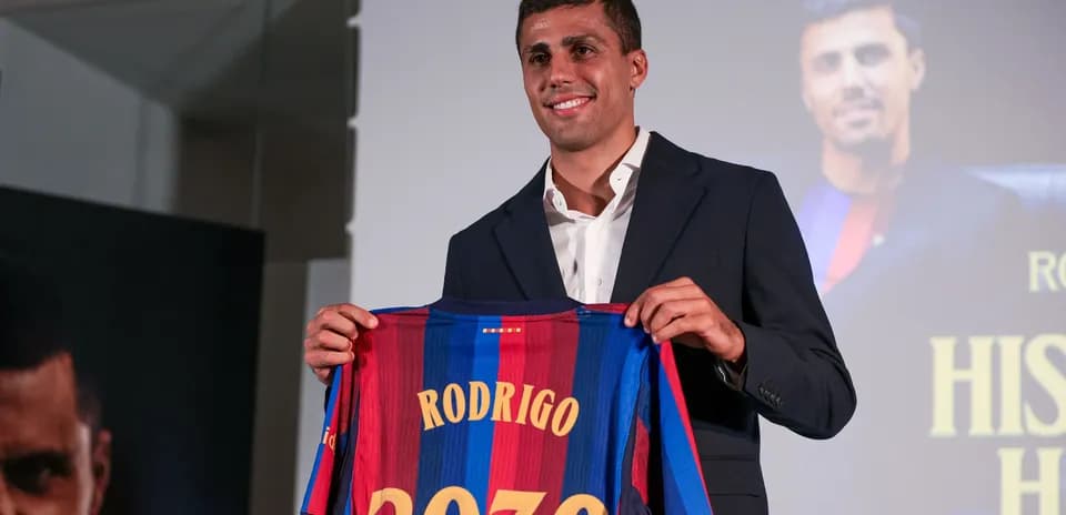 Player holding Barcelona jersey with name Rodrigo