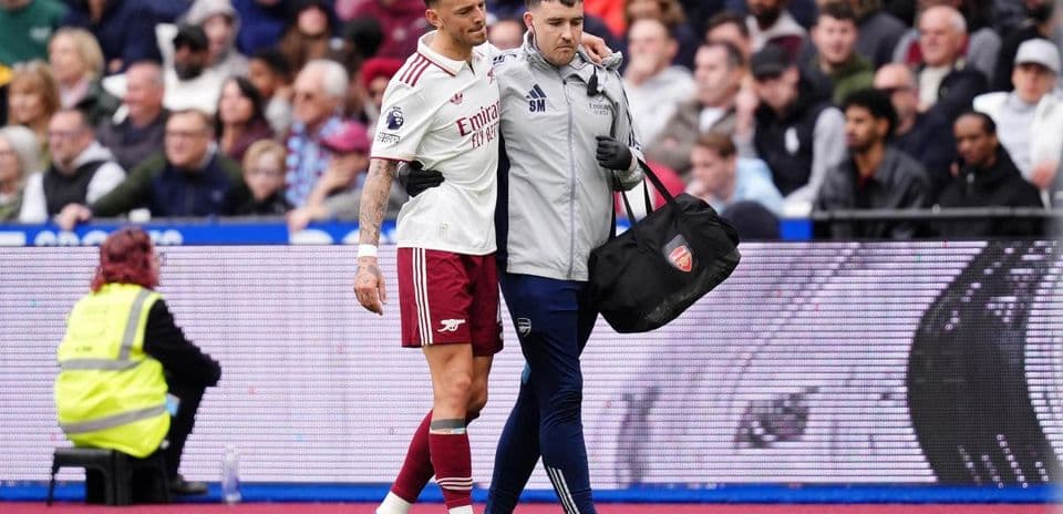 Player being assisted off the field by medical staff