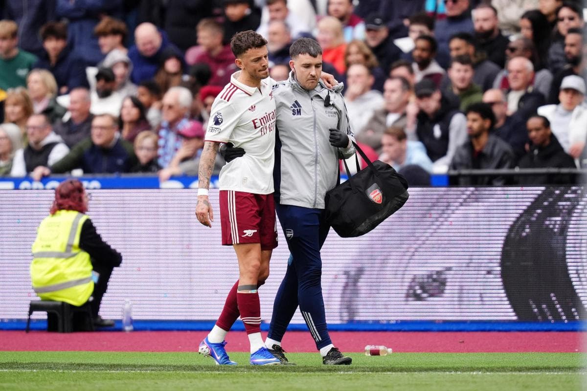Player being assisted off the field by medical staff
