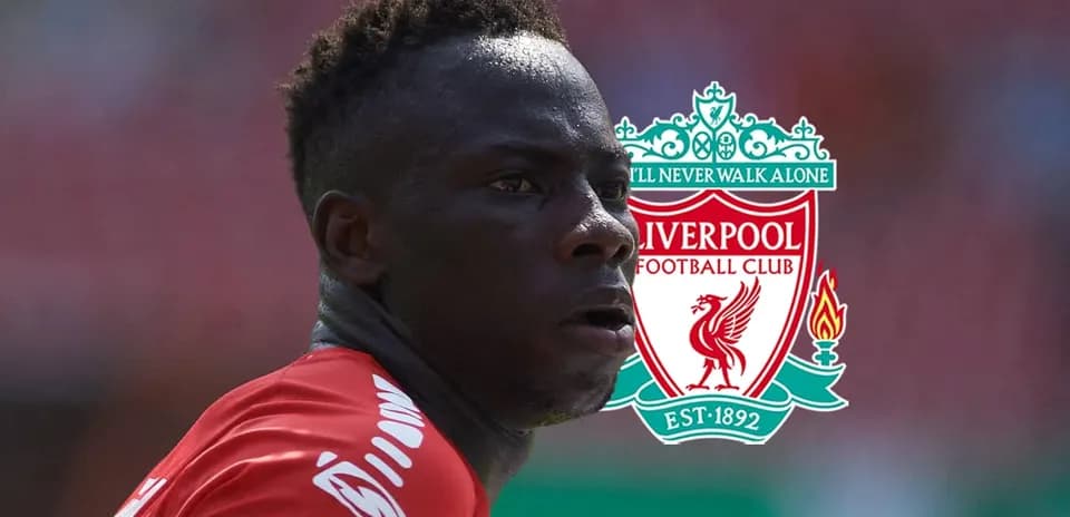 Player in Liverpool kit with club logo background